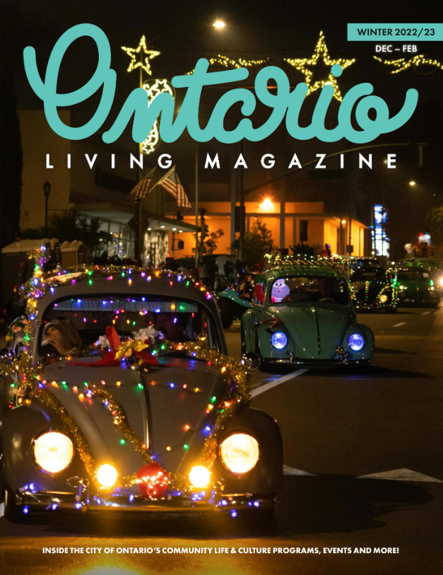 Night shot of a classic car decorated with bright, colorful holiday lights